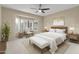 Cozy bedroom with bay window, plush carpet, ceiling fan, and neutral decor at 17882 N Painted Spurge Ct, Surprise, AZ 85374