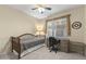 Cozy bedroom with a ceiling fan, carpet and natural light from the window above the built-in desk at 17882 N Painted Spurge Ct, Surprise, AZ 85374