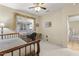 Bedroom featuring carpet, ceiling fan, a window over a built-in desk, and a bed; natural light at 17882 N Painted Spurge Ct, Surprise, AZ 85374