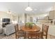 Bright, open dining area features a round table and seamlessly connects to the living room and kitchen at 17882 N Painted Spurge Ct, Surprise, AZ 85374