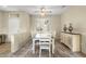 Charming dining room features tile floors and a wooden table set with white chairs at 17882 N Painted Spurge Ct, Surprise, AZ 85374