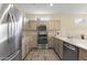 Clean kitchen featuring stainless steel appliances, tile flooring, and a functional layout at 17882 N Painted Spurge Ct, Surprise, AZ 85374