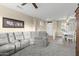 Bright living room features plush gray carpeting, a sectional sofa, and a view into the dining area at 17882 N Painted Spurge Ct, Surprise, AZ 85374