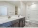 Bright bathroom featuring double vanity, shower and tub with modern fixtures and neutral tones at 1881 S 223Rd Dr, Buckeye, AZ 85326