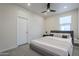 Serene bedroom with a plush bed, a ceiling fan, and ample natural light at 1881 S 223Rd Dr, Buckeye, AZ 85326