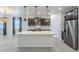 Modern kitchen boasts stainless appliances, center island with sink and pendant lighting at 1881 S 223Rd Dr, Buckeye, AZ 85326