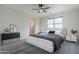 Calm main bedroom with ceiling fan, and bright natural light at 1881 S 223Rd Dr, Buckeye, AZ 85326