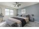 Comfortable main bedroom with a ceiling fan and bench at 1881 S 223Rd Dr, Buckeye, AZ 85326