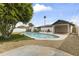 Spacious backyard featuring a refreshing swimming pool with a large tree and well-maintained landscaping at 1908 N 47Th St, Phoenix, AZ 85008