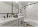 Modern bathroom featuring double sinks, large mirror, updated faucet fixtures, and a shower-tub combination at 1908 N 47Th St, Phoenix, AZ 85008