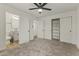 Carpeted bedroom featuring three closets and an ensuite bathroom offering convenience and storage at 1908 N 47Th St, Phoenix, AZ 85008