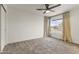 Bright and open bedroom with neutral carpet, large window, and views of the backyard landscape at 1908 N 47Th St, Phoenix, AZ 85008