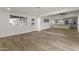 Bright living room with hardwood floors and views into the newly remodeled open kitchen and breakfast bar at 1908 N 47Th St, Phoenix, AZ 85008