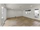 Bright living room with wood floors, a large window, and sliding doors to the backyard at 1908 N 47Th St, Phoenix, AZ 85008