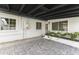 Covered patio with brick flooring, white walls, plants, and windows offering natural light at 1908 N 47Th St, Phoenix, AZ 85008