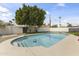 Backyard pool surrounded by lush greenery and a privacy fence under a sunny sky at 1908 N 47Th St, Phoenix, AZ 85008