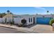 Single-story home with a blue garage door, desert landscaping, and an enclosed front courtyard at 2065 E Alameda Dr, Tempe, AZ 85282