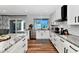 Modern, bright kitchen featuring white cabinetry, stainless steel appliances, and updated countertops at 2065 E Alameda Dr, Tempe, AZ 85282