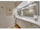 Bathroom features double sinks with white cabinetry and an oversized mirror at 20802 N Grayhawk Dr # 1017, Scottsdale, AZ 85255