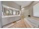 Elegant bathroom featuring a double vanity, soaking tub, and glass-enclosed shower at 20802 N Grayhawk Dr # 1017, Scottsdale, AZ 85255