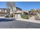 Exterior view of a home with an attached two-car garage and desert landscaping at 20802 N Grayhawk Dr # 1017, Scottsdale, AZ 85255