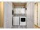 Laundry room featuring a washer, dryer, and white cabinets for extra storage at 20802 N Grayhawk Dr # 1017, Scottsdale, AZ 85255