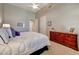 Well-lit main bedroom with a ceiling fan, vaulted ceiling, and a wooden dresser at 20802 N Grayhawk Dr # 1017, Scottsdale, AZ 85255