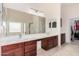 Bathroom featuring a large mirror, dual sinks, and wood cabinets at 21 W Red Mesa Trl, San Tan Valley, AZ 85143