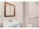 Bathroom with a vanity, framed mirror, commode, and grab bar at 21 W Red Mesa Trl, San Tan Valley, AZ 85143