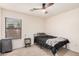 Well-lit bedroom with modern ceiling fan, closet, and bedside table at 21 W Red Mesa Trl, San Tan Valley, AZ 85143