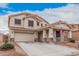 Charming two-story home with a two-car garage and a welcoming front porch, complemented by a well-maintained yard at 21 W Red Mesa Trl, San Tan Valley, AZ 85143