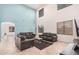 Bright, high-ceilinged living room featuring a blue accent wall, tiled floor, and ample seating at 21 W Red Mesa Trl, San Tan Valley, AZ 85143