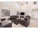 Bright, high-ceilinged living room featuring an entertainment center and ample seating at 21 W Red Mesa Trl, San Tan Valley, AZ 85143