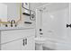 Modern bathroom with white vanity, black hardware, and a shower with tub at 2110 W Pampa Ave, Mesa, AZ 85202