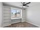 Cozy bedroom with carpet, a built-in desk and shelving, and a ceiling fan at 2110 W Pampa Ave, Mesa, AZ 85202