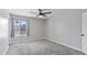 Bedroom with a ceiling fan, carpet, and a bright window providing natural light at 2110 W Pampa Ave, Mesa, AZ 85202