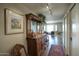 Hallway featuring wood flooring, track lighting, antique furniture, and view to the living room at 2201 N Central Ave # 11A, Phoenix, AZ 85004