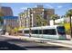 Modern light rail car in front of urban architecture with palm trees on a sunny day at 2201 N Central Ave # 11A, Phoenix, AZ 85004