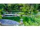 A serene Japanese garden pond featuring a stone lantern, lush greenery, and a pebble beach at 2201 N Central Ave # 11A, Phoenix, AZ 85004