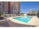 Condo saltwater pool with blue water, lounge chairs, and nearby high-rise condos at 2201 N Central Ave # 11A, Phoenix, AZ 85004