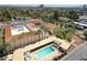 Community pool with clear blue water, lounge chairs, and covered seating areas at 2201 N Central Ave # 11A, Phoenix, AZ 85004