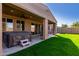 Backyard shows a covered patio with a hot tub, and steps leading to a well-manicured lawn at 22624 S 224Th Pl, Queen Creek, AZ 85142