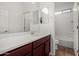 Bright bathroom with a modern vanity, a mirror, and a view of the tub at 22624 S 224Th Pl, Queen Creek, AZ 85142