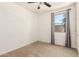 This bedroom features a ceiling fan and a window with gray curtains, offering a comfortable and well-lit space at 22624 S 224Th Pl, Queen Creek, AZ 85142