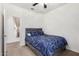 Well-lit bedroom featuring carpet, ceiling fan, and a comfortable bed with stylish bedding at 22624 S 224Th Pl, Queen Creek, AZ 85142