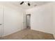 This bedroom boasts neutral walls, plush carpeting, a ceiling fan, and access to an adjoining room at 22624 S 224Th Pl, Queen Creek, AZ 85142