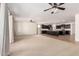 Spacious living room with ceiling fans, neutral carpet and view to the gourmet kitchen at 22624 S 224Th Pl, Queen Creek, AZ 85142
