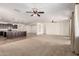 Large living room blending into an open kitchen and other living spaces with ceiling fans and recessed lighting at 22624 S 224Th Pl, Queen Creek, AZ 85142