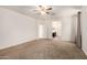 Spacious main bedroom with plush carpet, ceiling fan and view to the bathroom at 22624 S 224Th Pl, Queen Creek, AZ 85142
