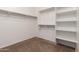 Well-organized walk-in closet offering ample storage with shelving and hanging rods at 22624 S 224Th Pl, Queen Creek, AZ 85142